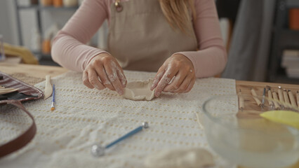 Woman hands shaping clay in a ceramics studio; creativity calm focus.