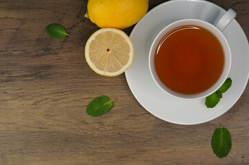 Top View of Hot Tea with Lemon and Mint on Wooden Table