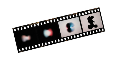A pristine black 35mm film strip featuring four distinct abstract images, horizontal with sprocket holes, on a transparent background with soft studio lighting. Concept of creative evolution and time