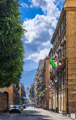 Palermo cityscape in Sicily, southern Italy. Glimpse of the Cassaro urban street: the Porta Nuova is in the background, historic citygate.