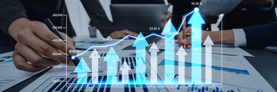 This image features a business analysis chart with digital growth trends displayed, surrounded by professionals collaborating in an office environment, symbolizing strategic financial planning. Scalp - Powered by Adobe