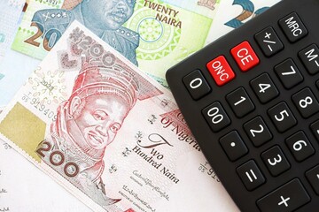 Nigerian naira currency money bills and calculator close up. The concept of taxation and money count