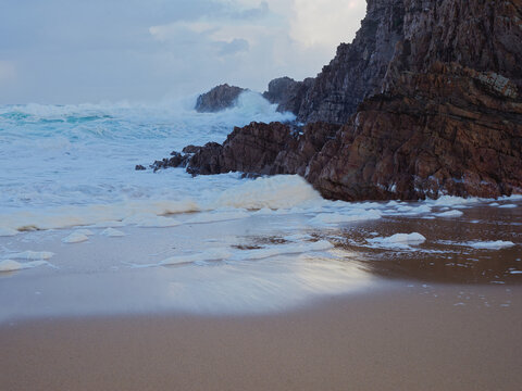 Ocean Waves Crashing Against Rugged Rocks on Murder Hole Beach in County Donegal Ireland