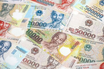 Vietnamese dong currency money bills. The current banknotes lies on table in big amount close up