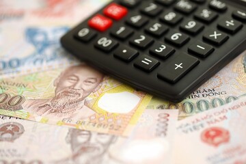 Vietnamese dong currency money bills and calculator close up. The concept of taxation and money count