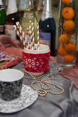 Winter Still Life: Drinking Straws, Mandarins, and Gold Holiday Garlands