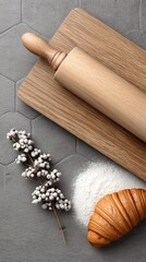 Croissants lie on a rolling pin, surrounded by kitchen essentials, showcasing a warm and inviting baking atmosphere
