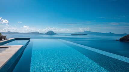 Fototapeta premium Stunning infinity pool overlooking tranquil ocean panorama with distant islands under a vibrant blue sky