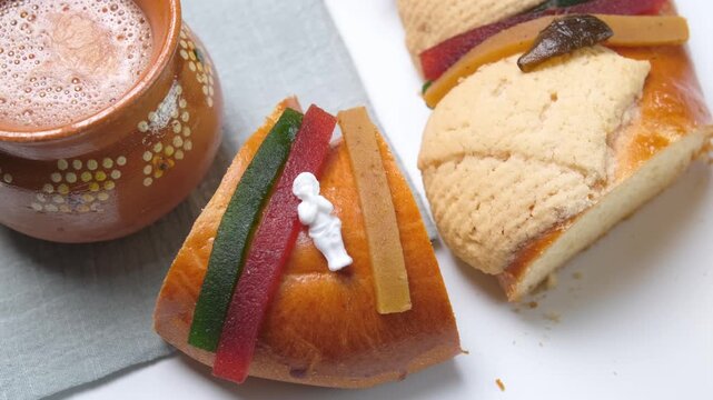 A slice of Mexican Rosca de reyes, king cake, epiphany cake, traditional bread