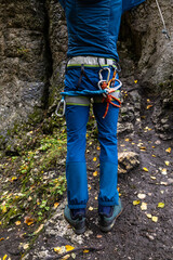 Close-up. An unrecognisable person with a set of ropes and carabiners attached to a climbing harness. Poland
