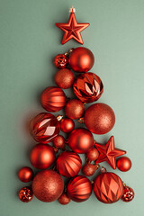 Green and Gold Christmas Ornaments Hanging on Pine Branches over Muted Green Background