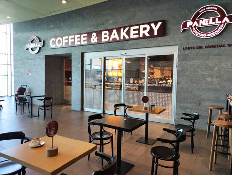 Rome, Italy - November 13, 2025: Panella Coffee & Bakery interior showcasing modern design with inviting atmosphere, featuring tables and chairs, perfect for enjoying pastries and beverages