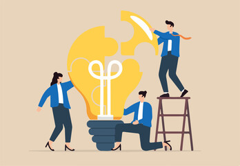 Business team solve lightbulb jigsaw puzzle together