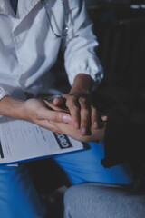 A female nurse caregiver holds hands to encourage and comfort an elderly woman. For care and trust in nursing homes for people of retirement age Caregiver helping elderly woman provides medical advice