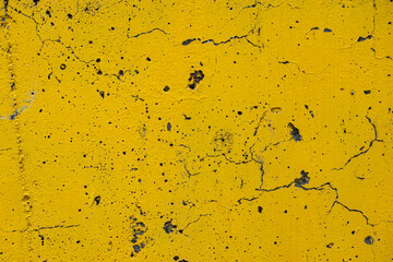 Background with an old, peeling wall painted yellow