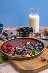 The balance between the wet elements (smoothie, fruit) and the dry elements (cereal, wood) creates an interesting visual dynamic