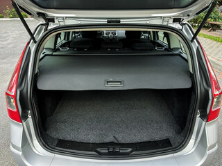 Spacious trunk of a sleek silver vehicle ready for adventure and road trips in a quiet parking lot...