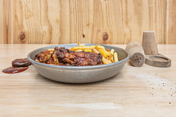 Extra crispy buttermilk fried chicken with sweet potato fries and spicy honey, served in a metal basket with a yogurt and herb dip