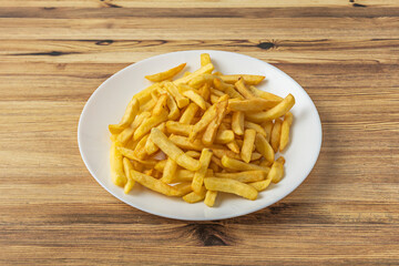 The circular arrangement of the chips around a central bowl of barbecue sauce creates a visually appealing and appetizing geometric composition