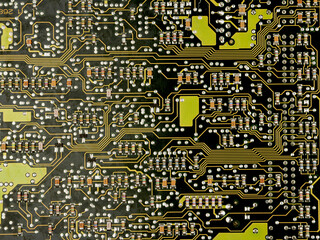 A close-up of a green printed circuit board from an electrical appliance or computer. Concept of electronics and microprocessor technology