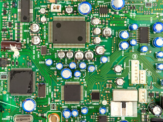 A close-up of a circuit board with microchips from an electrical appliance or computer. Concept of modern technology. Concept of electronics and microchips.