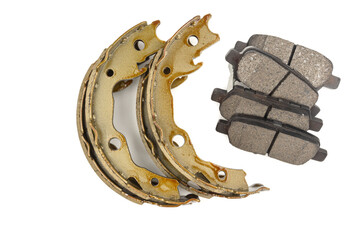 New front and rear car brake pads with dark gray friction material and a metal base, against a white studio background. Close-up