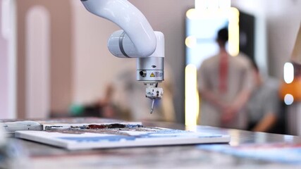 Robot arm painting abstract art during an exhibition exploring AI creativity