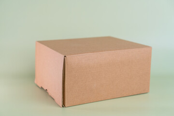 Mock-up of recycled eco friendly cardboard box, product and paracel packaging isolated on green background. Horizontal orientation.