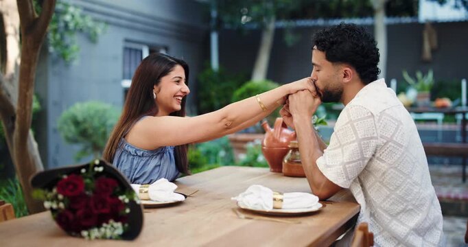 Hand, kiss, date and love with couple in restaurant for valentines day, roses and romance. Anniversary celebration, flower bouquet and gift with man and woman at table for support, care and marriage
