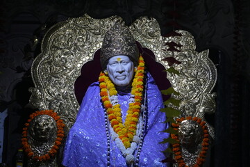 Sai Baba Idol Decorated with Floral Garland and Golden Throne