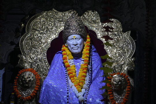Sai Baba Idol Decorated with Floral Garland and Golden Throne