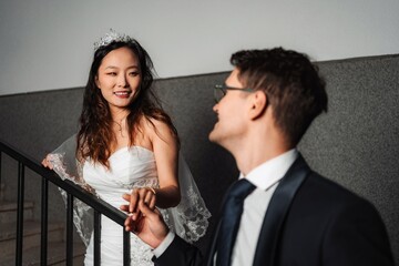 Interracial couple holding hands on wedding day