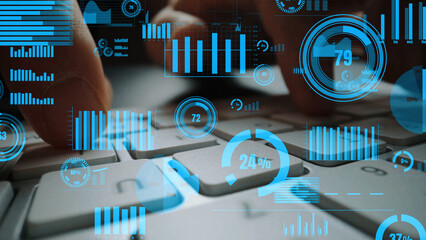 Close-up view of hands on a keyboard surrounded by graphical representations of data, emphasizing the importance of data analysis in modern business environments. Xenic