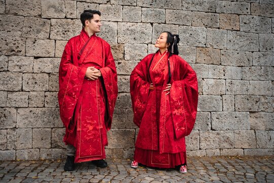 Interracial couple celebrating traditional Chinese wedding ceremony