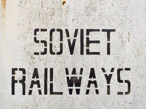Stencil inscription "Soviet Railways" on a beige background in grunge style