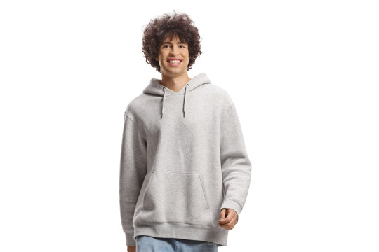 Guy with curly hair in a gray hoodie and jeans walking towards camera