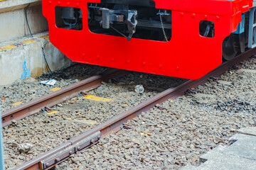Close-up view of the train coupler mechanism on KRL commuter line, showing the technical component connecting electric rail cars