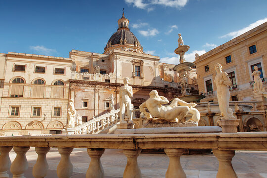 Historic European Square With Fountain and Statue Sculptures in Sunny Courtyard