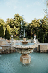 A classical stone fountain with flowing water in the central cascade of Valea Morilor Park in Chisinau, Moldova. 