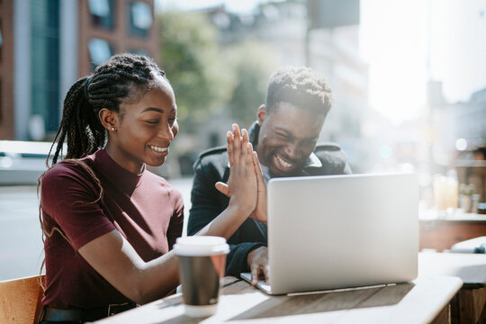Happy colleagues celebrating success image