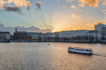 View of the Alster lake with an Alster steamer at golden hour