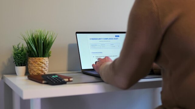 Middle Aged Man Working Remotely From Home Conducting Cybersecurity Audit for Consulting Firm - Information Security Concept