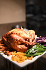 Christmas dinner plate featuring roasted turkey with root vegetables, Brussels sprouts, mashed potatoes, green beans, carrots, fresh salad, plus classic sides like stuffing, gravy and cranberry sauce.