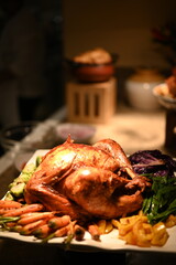 Christmas dinner plate featuring roasted turkey with root vegetables, Brussels sprouts, mashed potatoes, green beans, carrots, fresh salad, plus classic sides like stuffing, gravy and cranberry sauce.