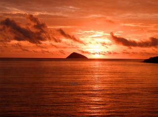Fiery Sunset over a Secluded Island in the Ocean