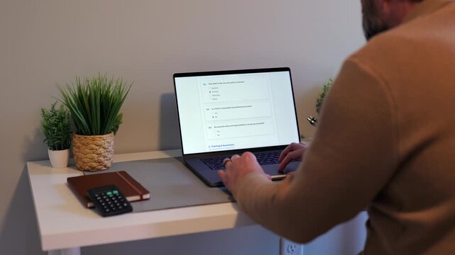 Middle Aged Man Working Remotely From Home Conducting Cybersecurity Audit for Consulting Firm - Information Security Concept