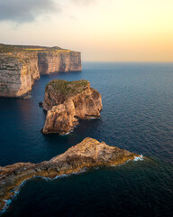 View of stunning cliffs and coastal scenery along the shores of Gozo in Malta during sunset