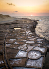 Exploring the historic salt pans of Gozo, Malta during sunset