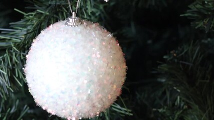 Sparkling White Glitter Christmas Ornament Hanging on a Green Fir Branch - Powered by Adobe