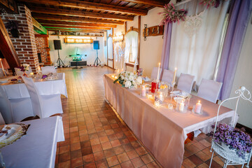 Elegant banquet hall decorated with floral arrangements, candles, and soft lighting, creating a romantic atmosphere for special events and celebrations